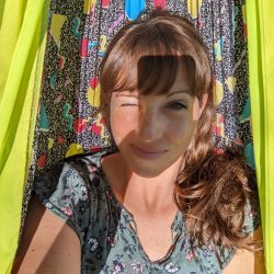 girl in hammock with one eye open where shadow of phone is blocking sun